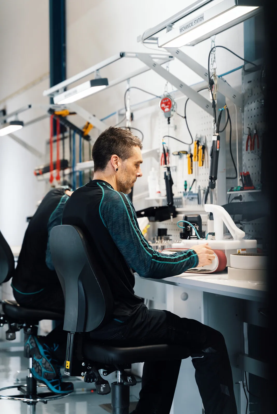 An engineer assembling a unit at the electronics bench