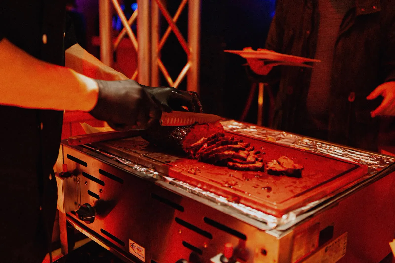 Beef being carved on the grill at the launch event