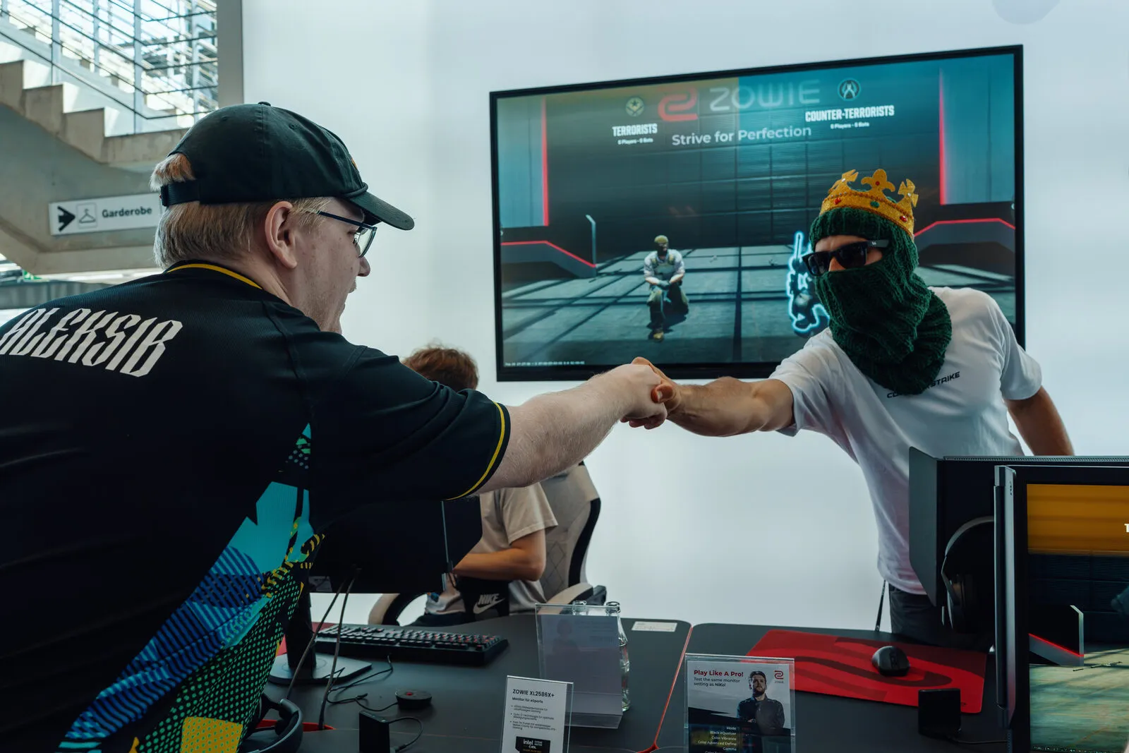 A fist bump across the desk at the end of a run on the aim challenge