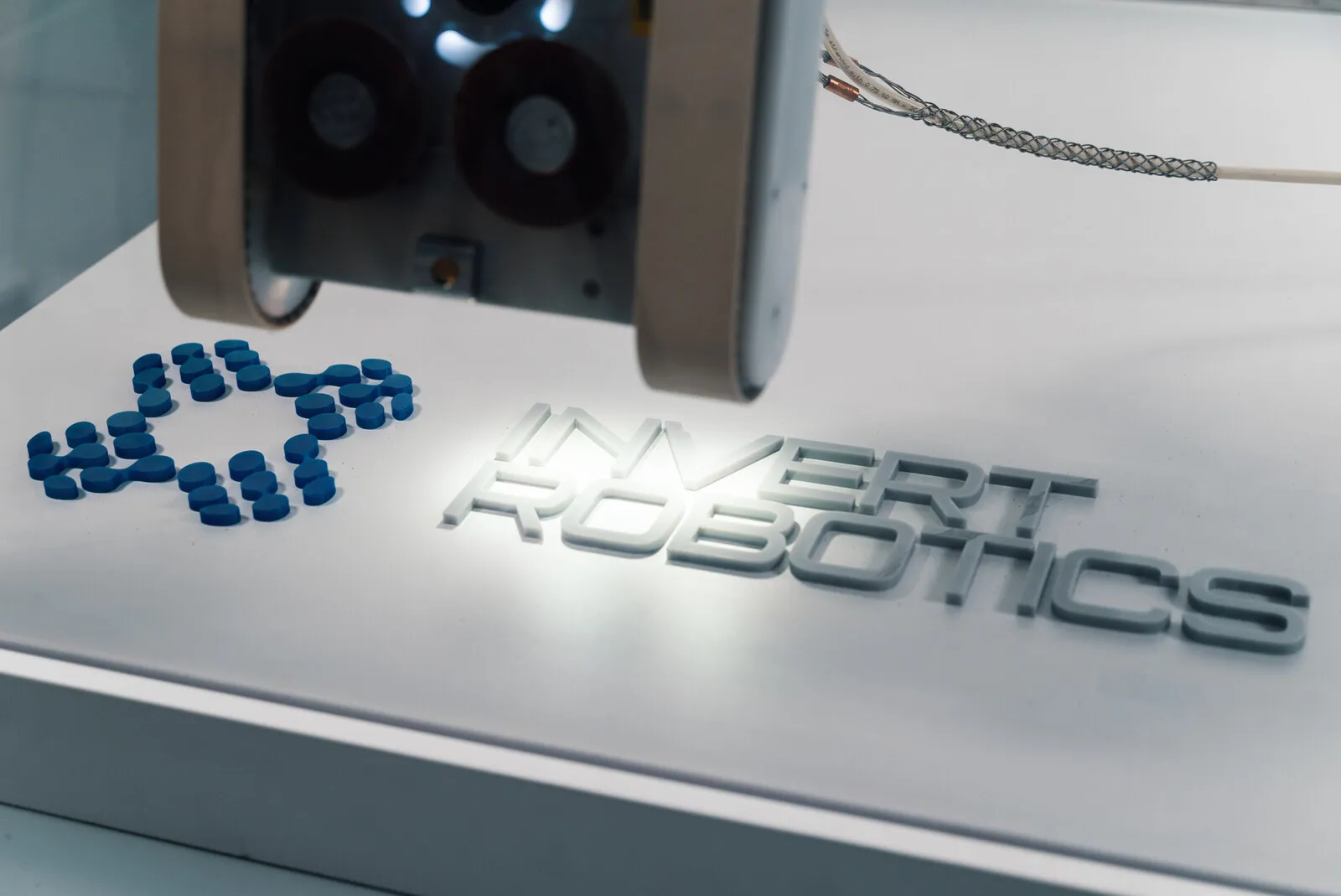 The Invert Robotics mark embossed on the white housing