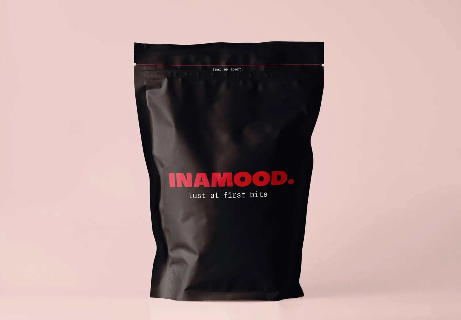 The black INAMOOD pouch on a blush background