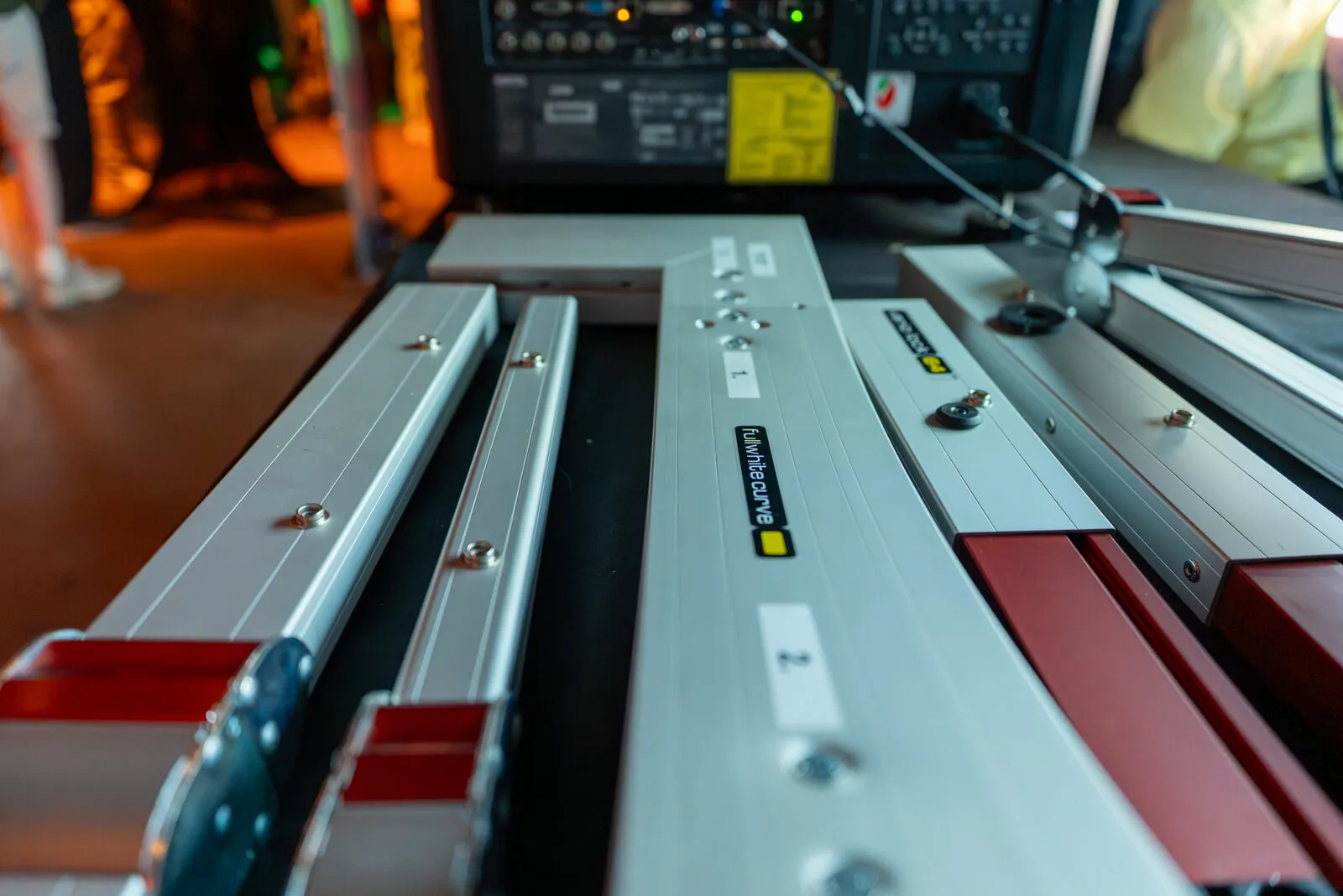Interchangeable projector lenses laid out in a row on the demonstration table