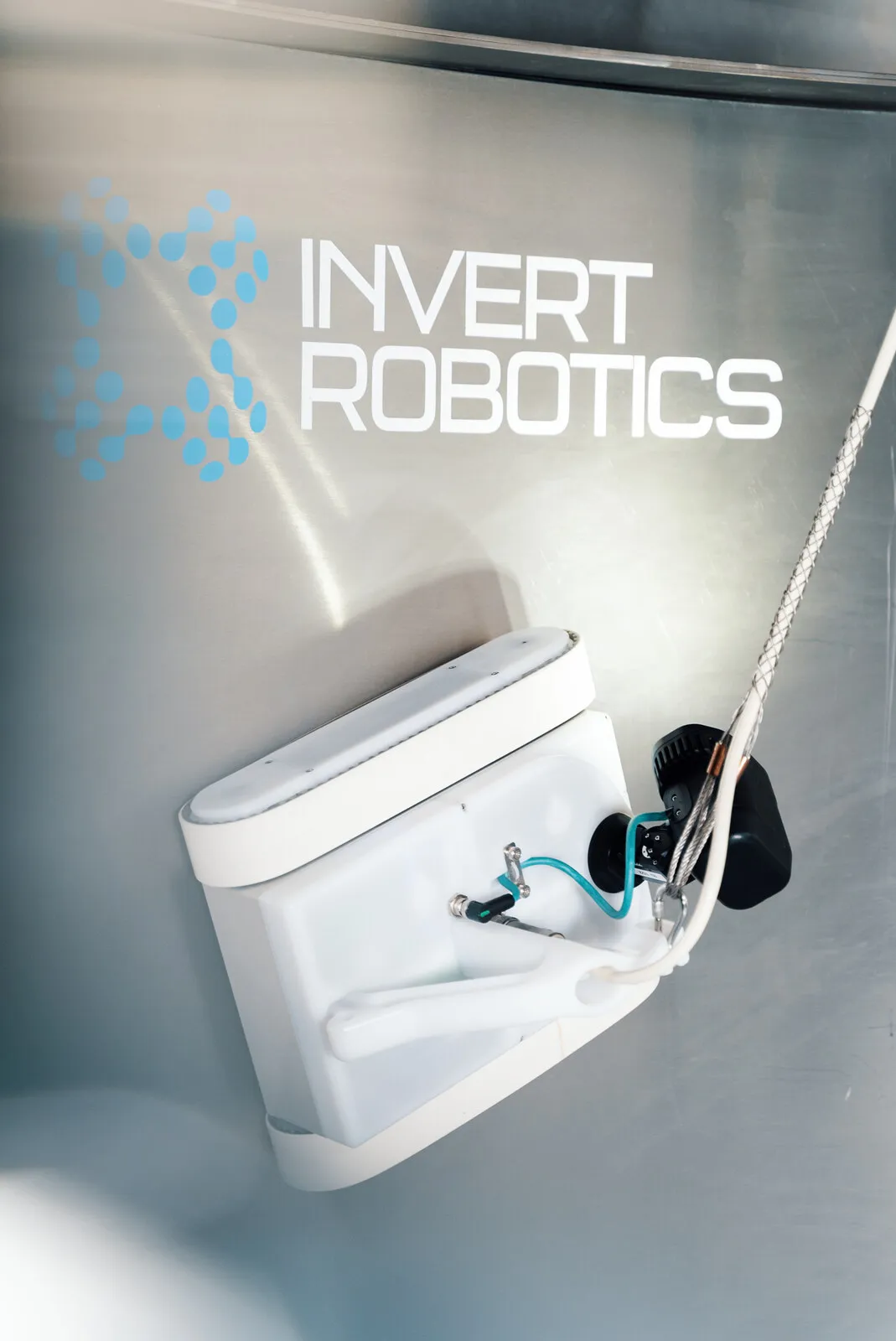 The Invert Robotics crawler holding itself against a sheer steel wall on its tether