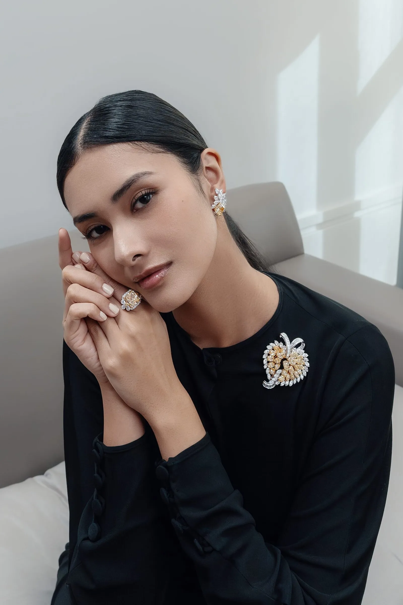 Yellow diamond brooch and matching ring worn with black in the upstairs rooms