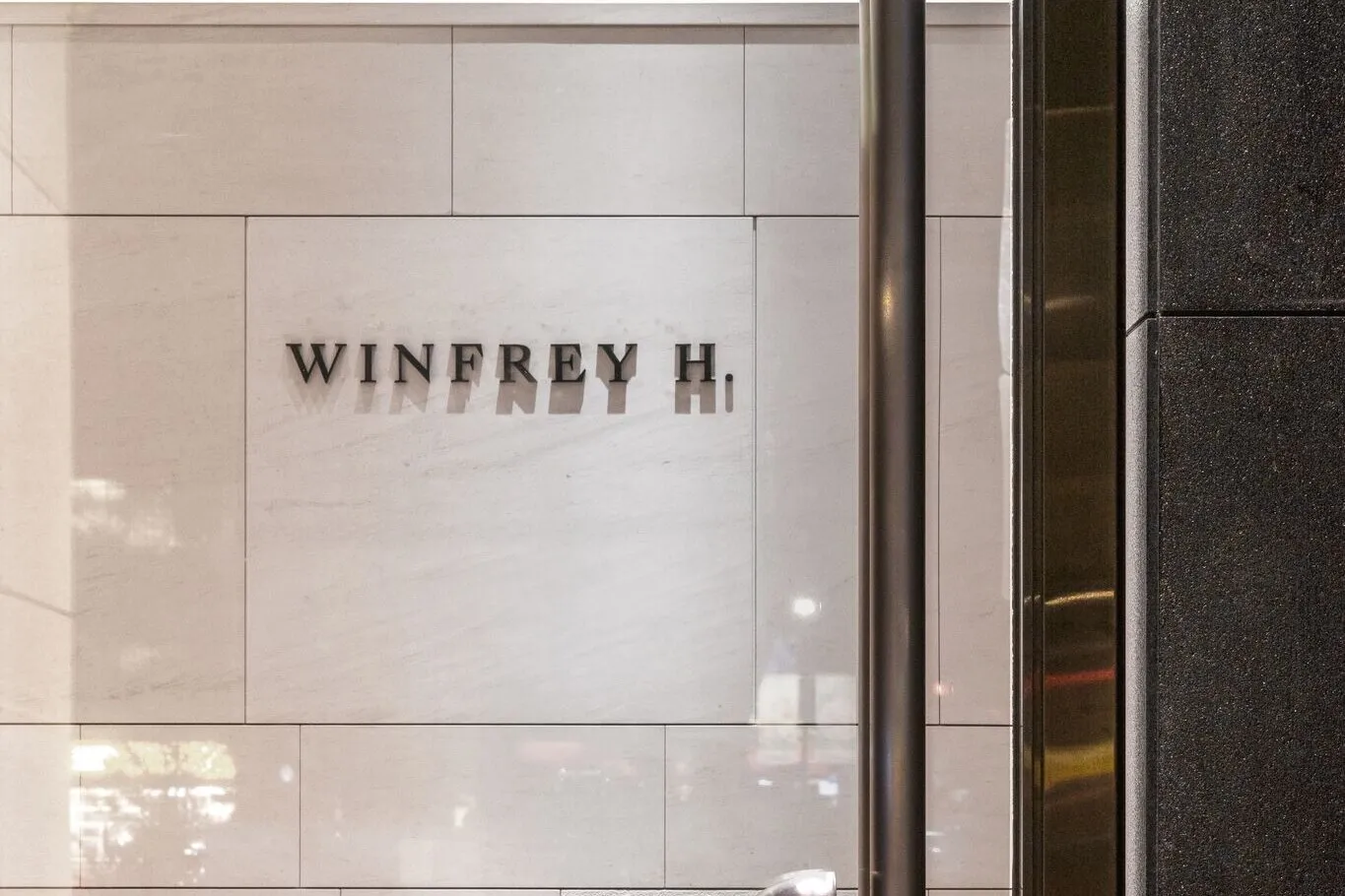 The Winfrey H. lettering mounted on the stone wall of the storefront