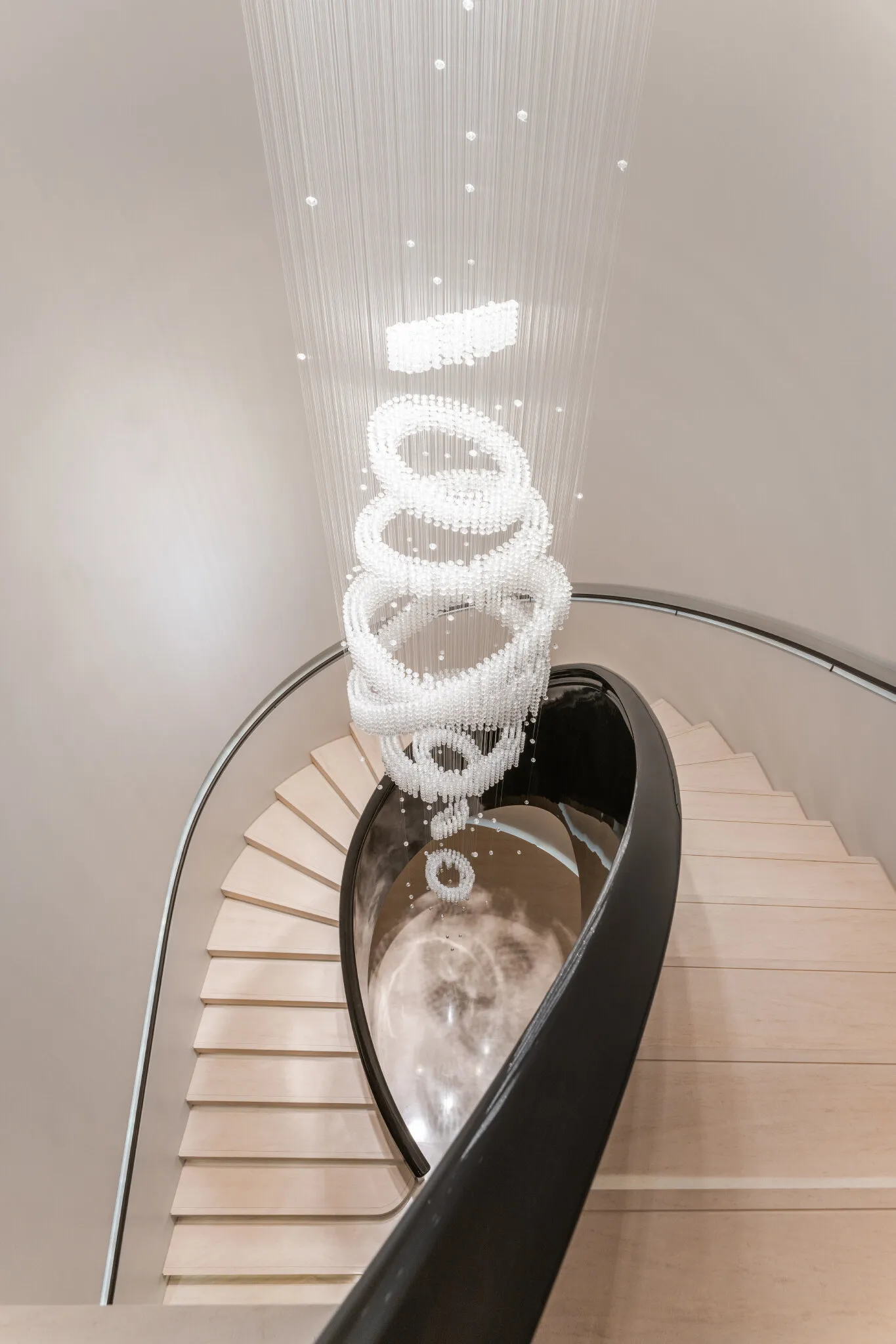 Looking down the stairwell at the crystal chandelier hanging through the spiral