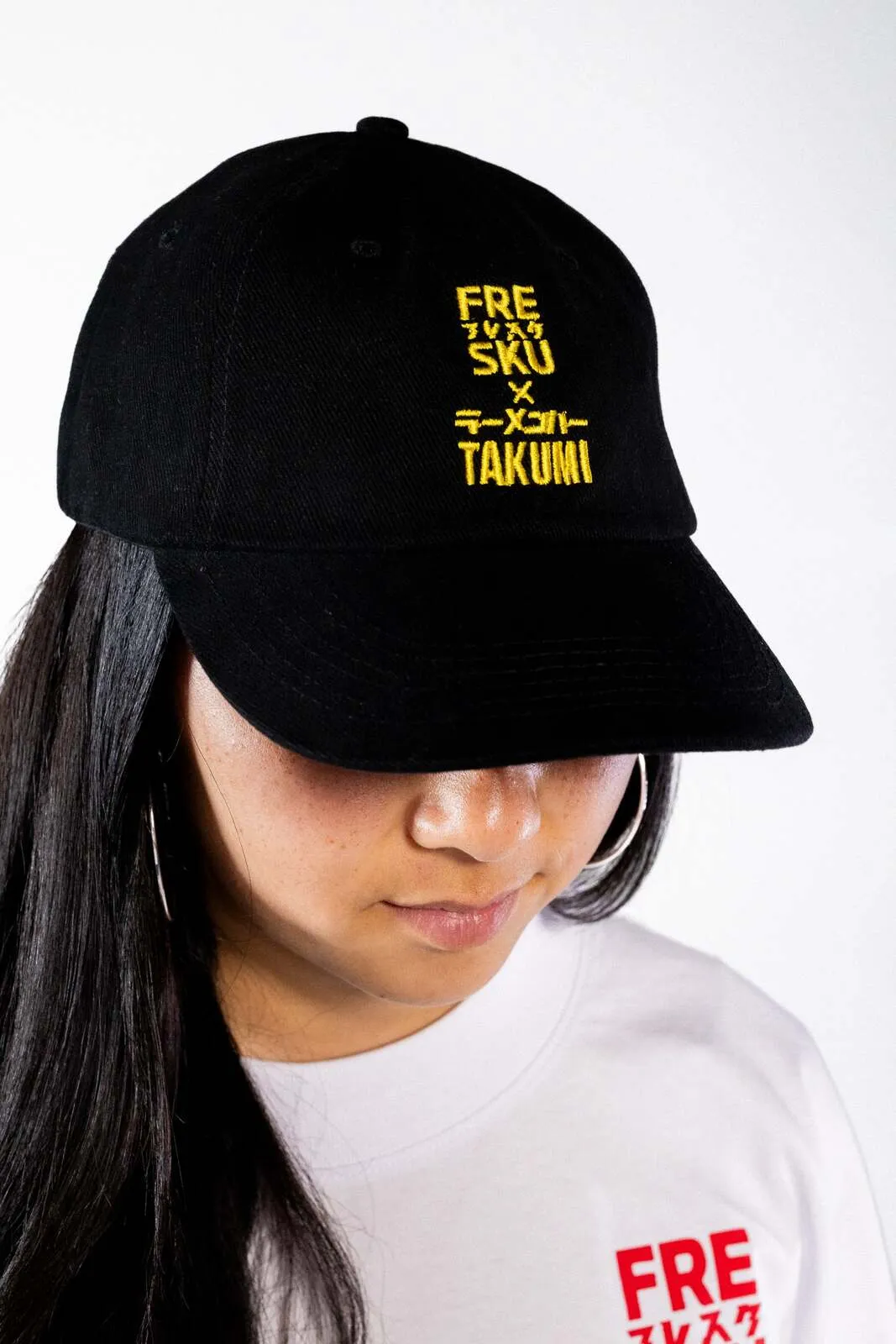 The six-panel Fresku x Takumi cap, embroidered at the front